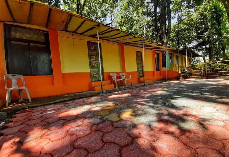 Row of guest rooms among the trees at Dandeli Jungle Camp